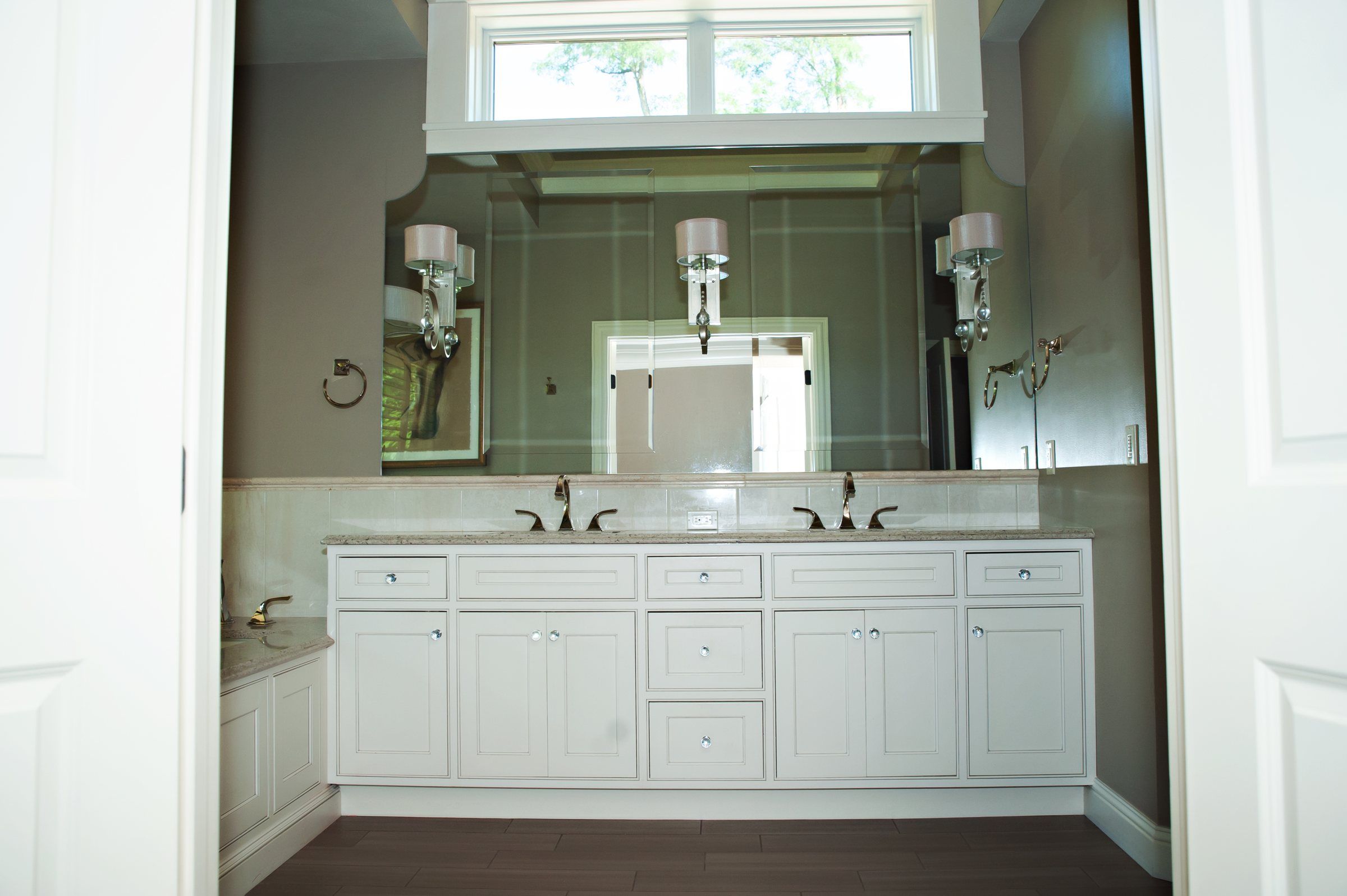 Master bathroom with a white double vanity and two faucets
